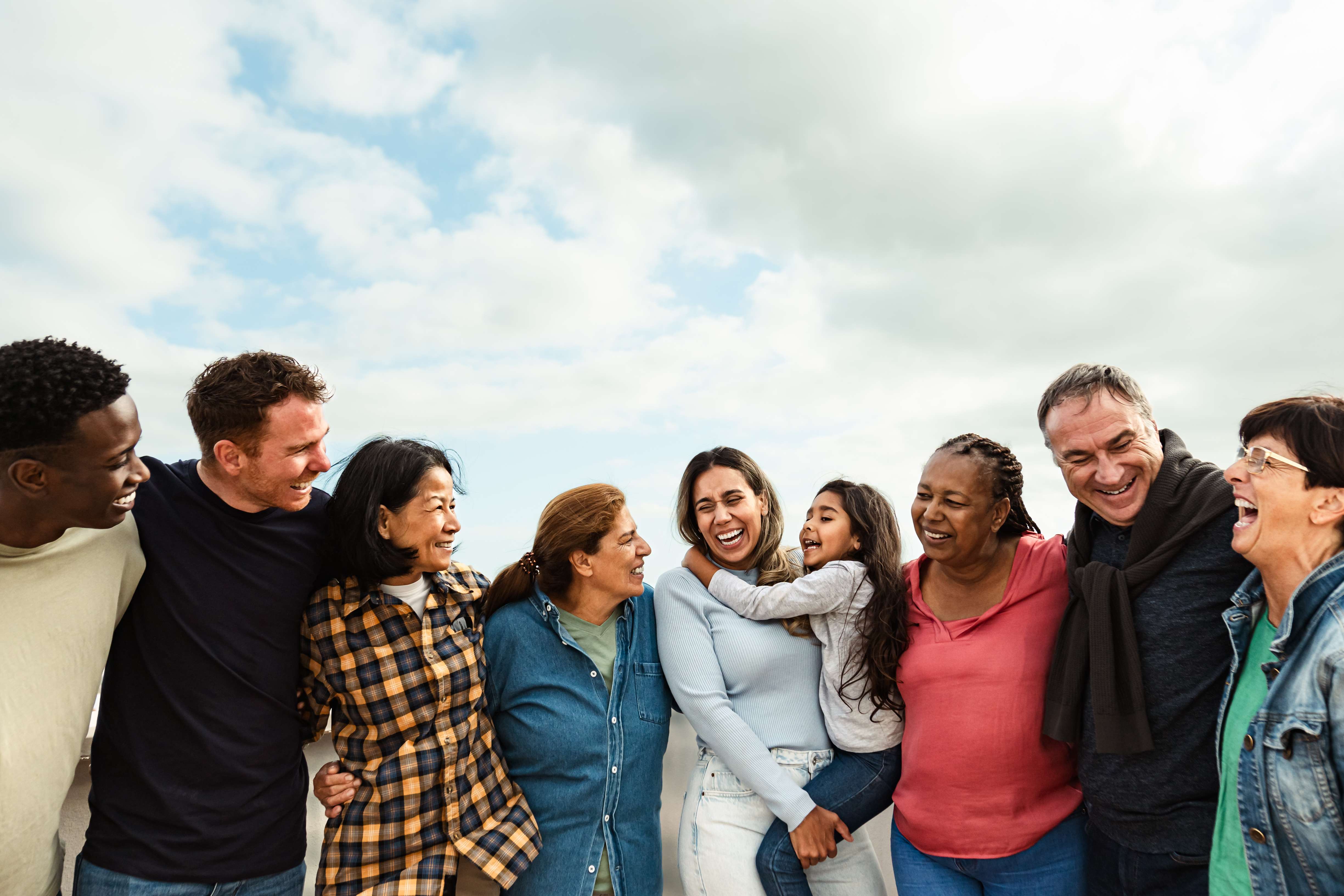 Happy multigenerational friends with different ethnicity having fun at house rooftop
