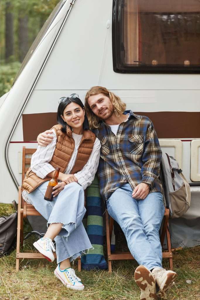 Couple Relaxing by RV Van